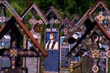 The Merry Cemetery at Sapinta. The crosses depict the deceased in question, and the writing tells what he/she did in life with a humorous twist.