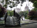 Bridge sculpture with Parliament building in the background. The guy on the bridge is a sculpture too and is PART of the bridge. Some guys were getting married. My favorite photo taken in Budapest.