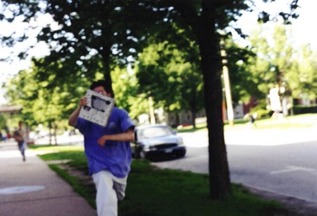 Matthew attemps, unsuccessfully, to hide his photogenic self from the camera