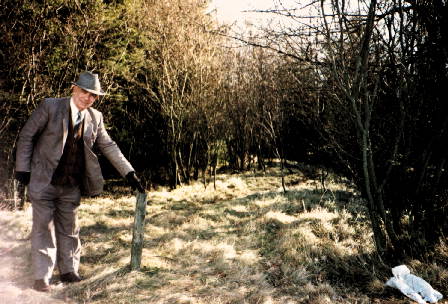 Dr Davie indicating an ancient marker stone near Falkirk, Scotland: Photograph Copyright Milson Macleod 1990