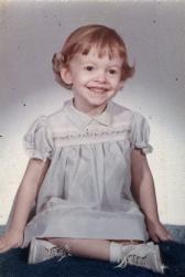 Me at 2 yrs. I was too young to be bothered by that flippy-do thing mother did with my hair ;)