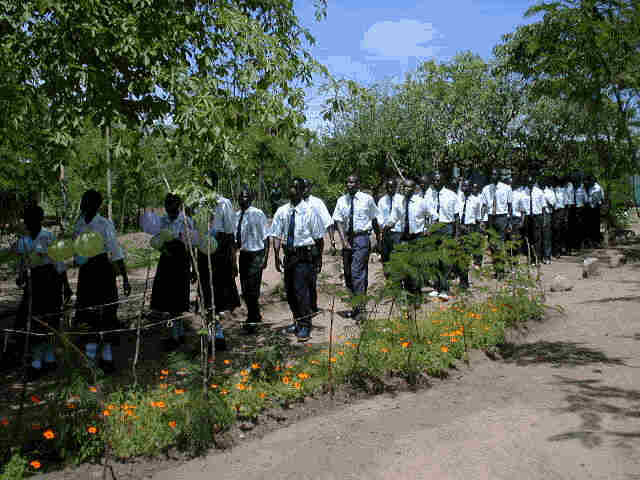 Los graduados hacen su entrada al patio.