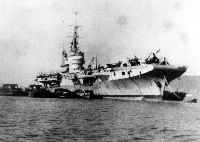 Unloading the Corsairs onto barges at Iwakuni, Japan