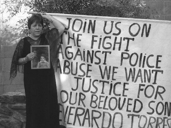 mother of Everardo Torres with banner