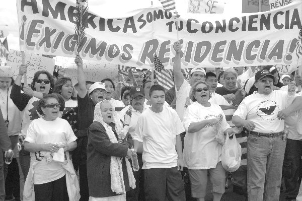 2006 marchers in Fresno, with Spanish banner 'America, we are your conscience, we demand residency'