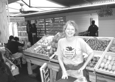 Debra Reiger in P&F t-shirt, fruit and vegetables behind her