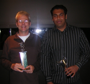 Photo of Barry Schwass and Muni Anand with Presidents C trophies. 