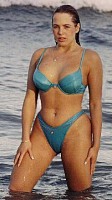 Cordelia stands in the sea in blue bikini