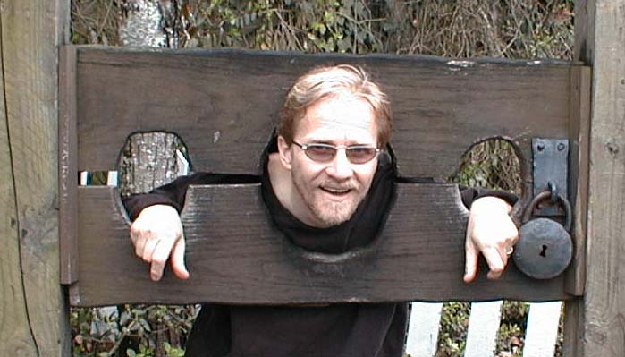 Jeff, who walked past this pillory many times, but finally couldn't resist, Dollywood, March 31, 2001