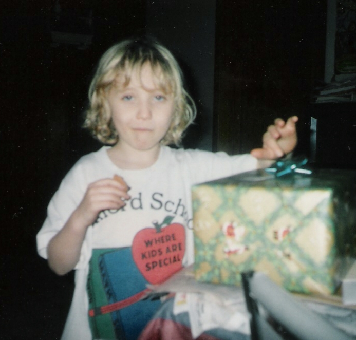 Kate on Christmas morning 1996, opening a present from friends Carl and Edna Blier