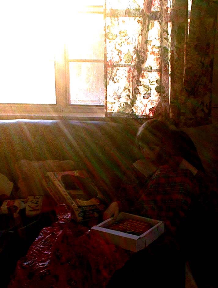 In the view finder, the rising sun wasn't as noticeable shining down on Kate and her presents, Christmas 2000