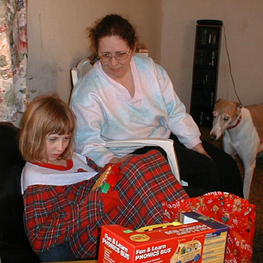 Kate, Cathy, and Cimmy survey Kate's bounty from Santa, Christmas 2000