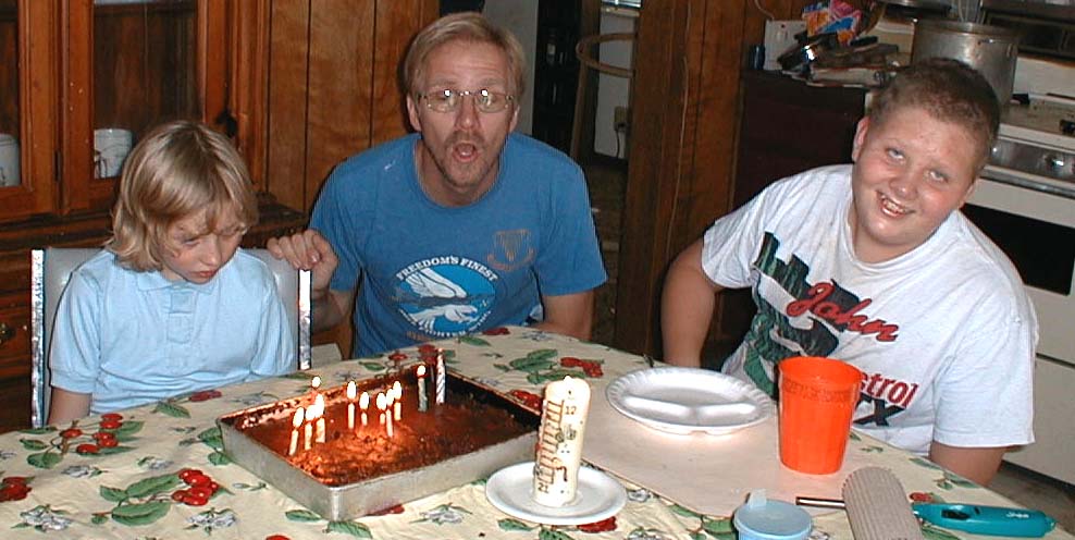 Kate, Jeff, and Luke blowing out the candles on Luke's 13th birthday, September 12, 1999