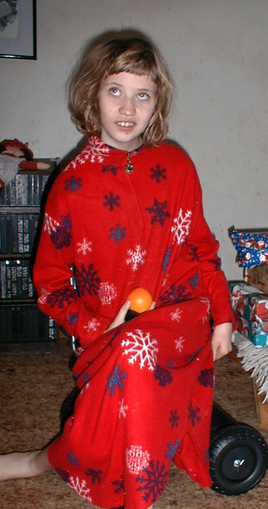 Kate on her new wheel cart thing, December 25, 2002