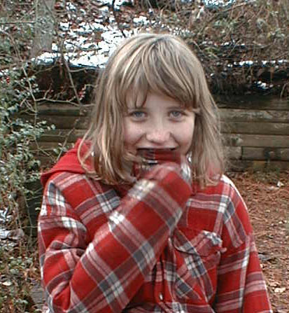 Kate back at the pine tree in winter on the first snow holiday of 2002, January 7