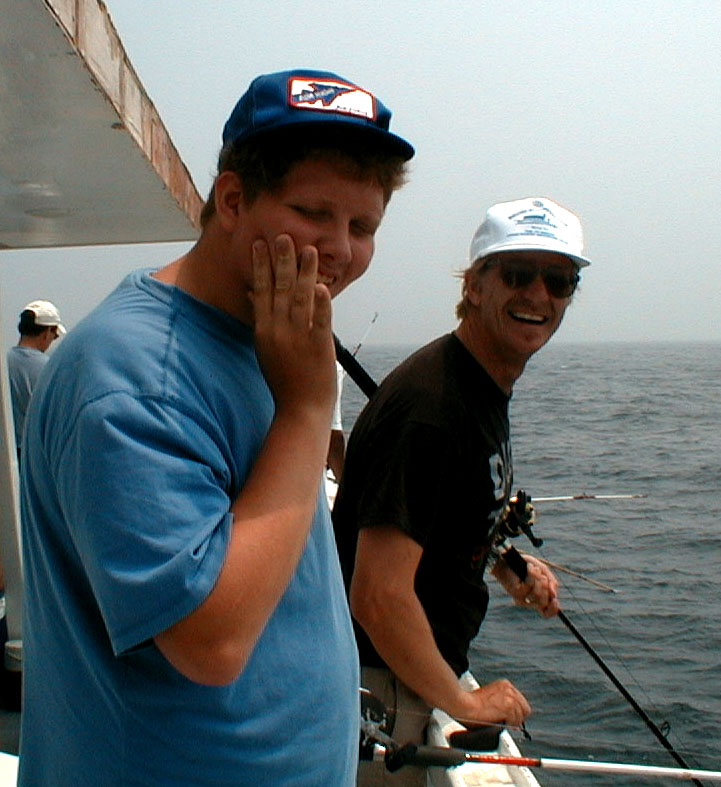 Dad, who taught you how to hold a fishin' pole?  No wonder I caught our only keeper; July 19, 2002