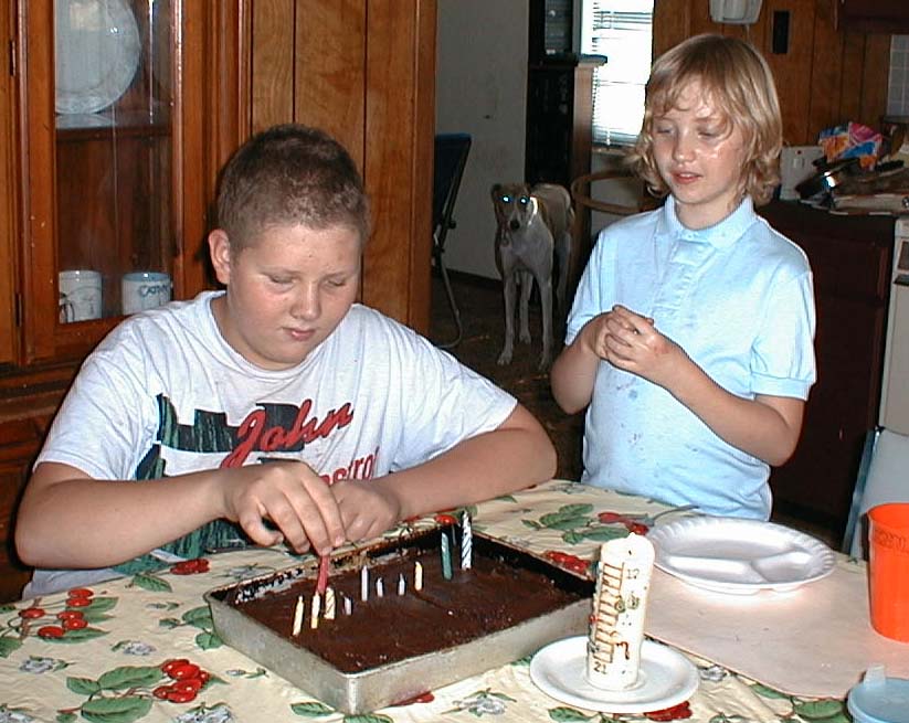 Luke and Kate blowing out the candles on Luke's 13th birthday, September 12, 1999