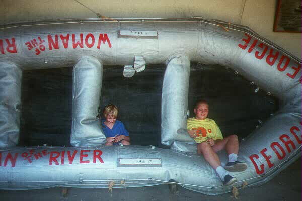 Luke and Kate testing out one of the vessels that ran the Colorado River's rapids, Grand Canyon Visitor's Center, July 12, 1998