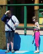 Luke and Kate playing chicken with the water jets in Dreamland Forest, April 1, 2002