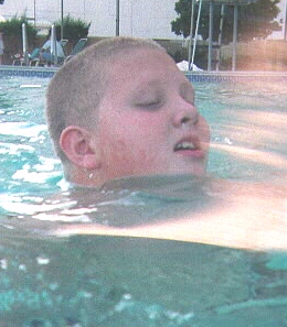 Luke showing that 6 years of public education-funded swimming lessons haven't been wasted.  Reno Hilton's pool.  July, 1998