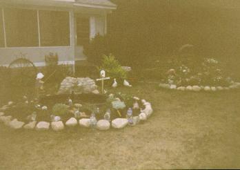 view of the pond and the bucket of flowers