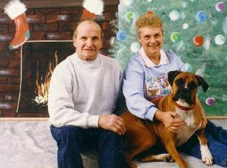 photo of a blonde lady in blue sweatshirt and man in white shirt and a boxer.