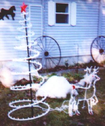 lighted tree and deer in the front yard