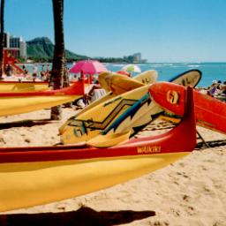 Outriggers and surfboards on the beach in Waikiki