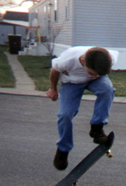 Nathan ollying on his scateboard