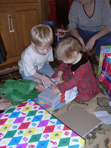 and Mason helps her open - a cool wind-up train!