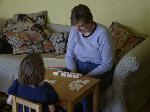 Mama and Jordan playing dominoes