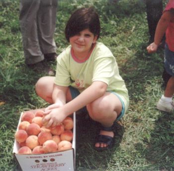 Shira with a box of peaches