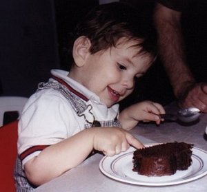 Yovel with his finger in the birthday cake