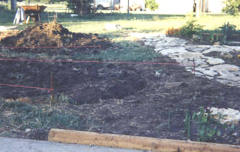 The grass removed and if you look closely, you can see the line level we used to build up the slight slope