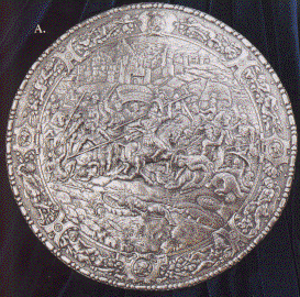 round silver shield carved in great detail