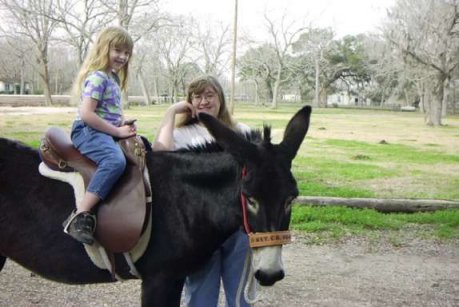 Kasey riding BeBe, with Mommy's help