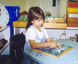 Emma learning to tie a bow