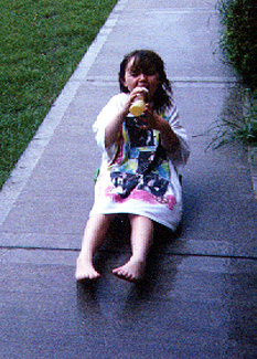 Amanda sitting on the sidewalk outside our town house