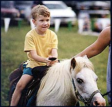 Riding a pony at 4