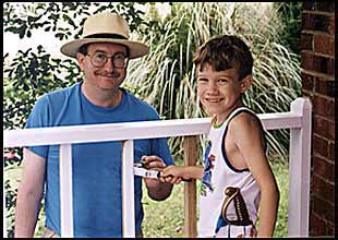 Benjamin helping paint porch rails