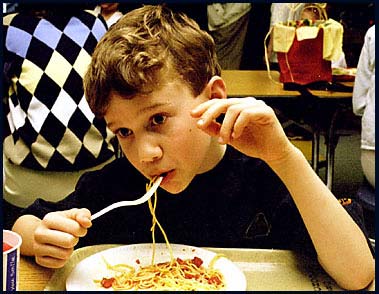 Eating spaghetti at school