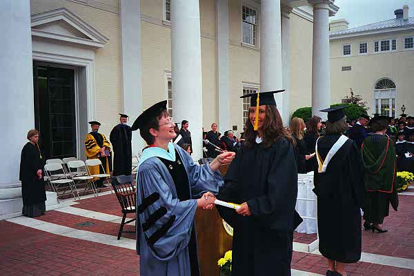 Brooke receiving congratulations from the Dean of Students