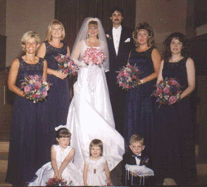 the bridesmaids and children with the bride and groom