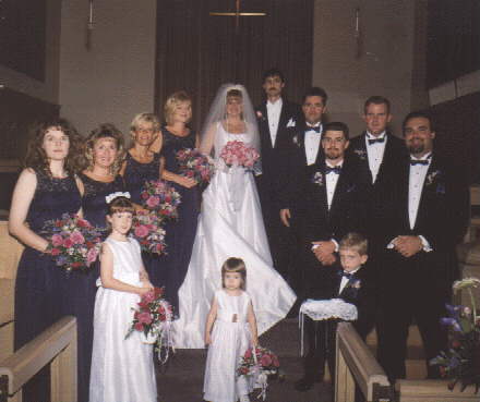 the entire wedding party poses with the bride and groom