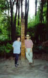 Mum and dad next to a totem pole in the village