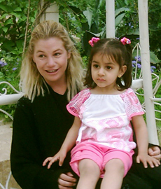 Marla Ruzicka, killed by roadside bomb, with Iraqi child.