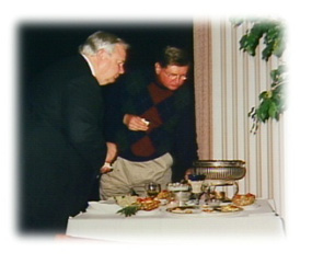 Mr. Kerr and former WOWT weathercaster Mr. Dale Munson look to see what's left of a buffet table.