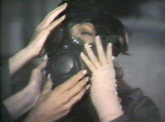 Kelly wearing a gasmask