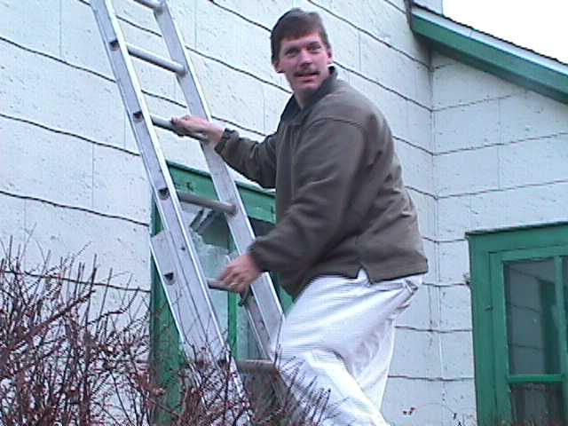 Paul helps hang the Christmas Wreath