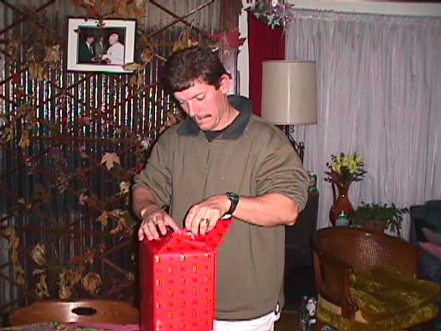 Paul opens his Christmas gift from Tony early because Tony will be in Cyprus for the holidays